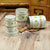 Organic Super Seven Mushroom capsules in front of an ancient tea chest on a dark wooden floor.